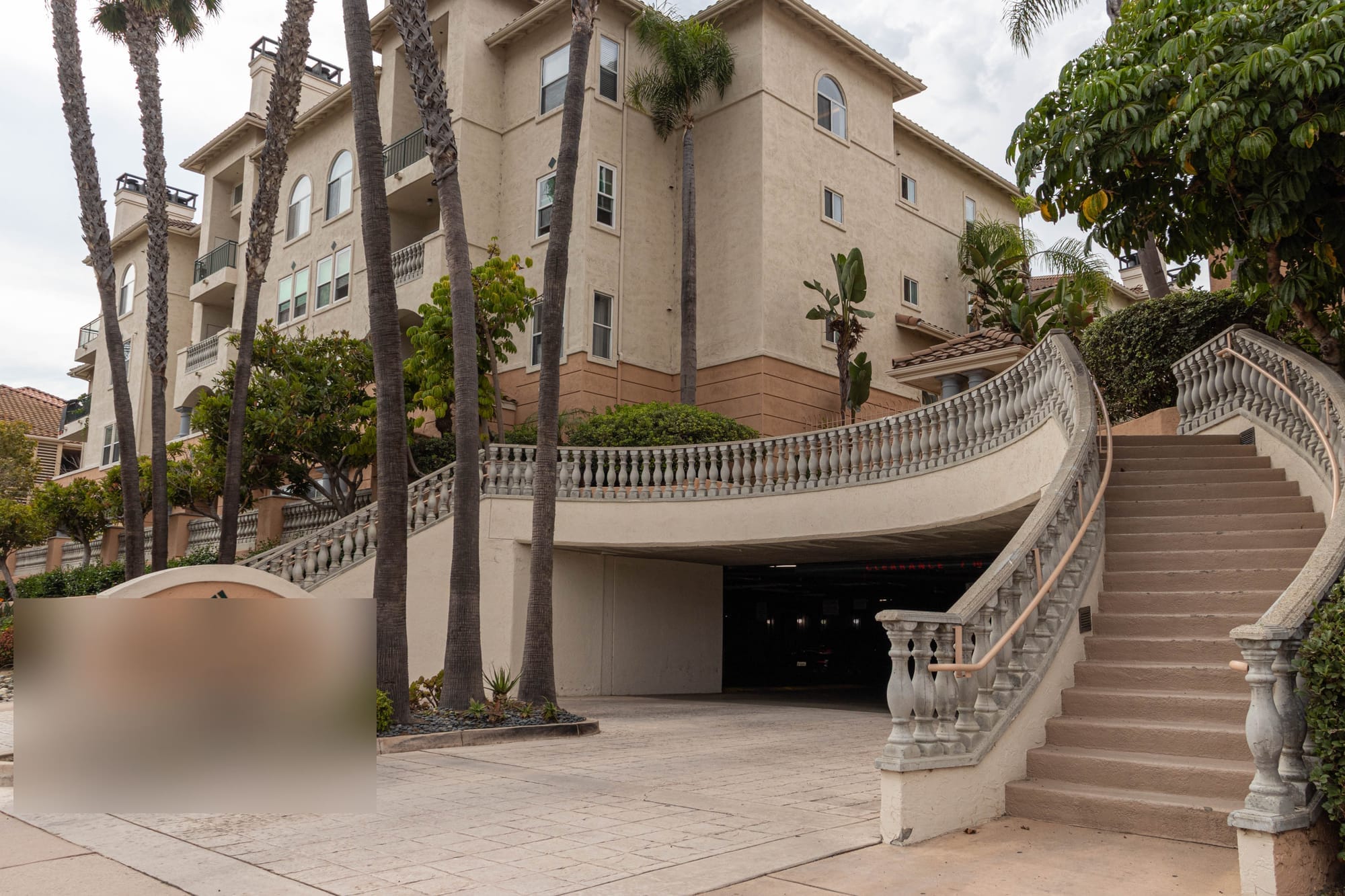 Grand palm-lined entrance staircase of a Mediterranean-style residence